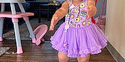 Nevayla joined the competition — help win amazing prizes! baby, carpet, child, couch, curtains, cute, furniture, headband, high_chair, home, indoor, living_room, person, purple_dress, sandals, toddler, toy, walking, window, wooden_floor