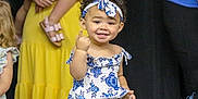 Nevayla joined the competition — help win amazing prizes! adult, blue_and_white, child, curly_hair, cute, dress, fashion, finger_gesture, floral_pattern, group, happy, headband, indoor, people, person, pink_sandals, portrait, smile, toddler, yellow_dress