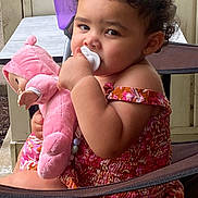 Nevayla is registered to the contest to win money with this photo: toddler, child, pacifier, plush_doll, curly_hair, pink_clothing, floral_pattern, chair, sippy_cup, table, porch, outdoor, baby, cute, person, portrait, sitting, young_child, indoor_outdoor, furniture