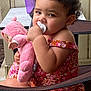 Nevayla is registered to the contest to win money with this photo: baby, chair, child, curly_hair, cute, floral_pattern, furniture, indoor_outdoor, outdoor, pacifier, person, pink_clothing, plush_doll, porch, portrait, sippy_cup, sitting, table, toddler, young_child