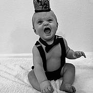 Jett joined the competition — help win amazing prizes! baby, crown, bow_tie, suspenders, black_and_white, smiling, happy, infant, sitting, blanket, cute, portrait, child, one_half, celebration, indoor, expression, toddler, clothing, face