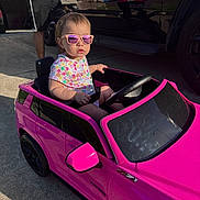 Chloe joined the competition — help win amazing prizes! adult, casual, child, concrete, controller, drive, garage, outdoor, pink_car, play, reflection, shorts, sidewalk, summer, sunglasses, sunlight, toddler, toy_car, tshirt, vehicle