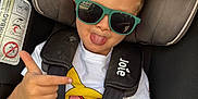 Ethan a rejoint le concours — aidez-le/la à gagner de superbes lots ! child, toddler, car_seat, sunglasses, tongue_out, pointing, shirt, pikachu, seatbelt, joie_brand, car_interior, window, hair, casual_clothing, playful, person, seat, fun, young_child, safety