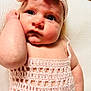 Alanni is registered to the contest to win money with this photo: baby, infant, face, blue_eyes, pink_headband, knitted_clothing, hand, close_up, skin, portrait, cute, resting, expression, soft_texture, white_background, child, newborn, looking_away, indoors, cozy