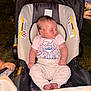 baby, sleeping, car_seat, pink_shirt, outdoor, night, infant, cute, child, peaceful, cartoon_print, small_toddler, clothing, feet, head, person, seat, relaxing, young, childcare