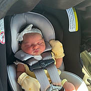 Ellie joined the competition — help win amazing prizes! baby, newborn, car_seat, sleeping, infant, mittens, headband, child, safety_harness, foot, seatbelt, sunlight, cute, indoors, child_seat, peaceful, person, baby_clothes, car_interior, resting