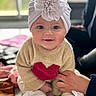 Anaya participe au concours pour gagner de l'argent avec cette photo : adult_hand, baby, child, cute, eyes, flower, hands, headband, heart, indoor, infant, person, red, seated, skin, smiling, soft_focus, sweater, warm_clothing, white