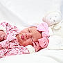 Anaya participe au concours pour gagner de l'argent avec cette photo : baby, newborn, sleeping_baby, pink_headband, bow, stuffed_toy, teddy_bear, blanket, bedding, cozy, infant_clothing, tiny_hand, lips, peaceful, portrait, soft_light, white_background, closeup, nursery, swaddle