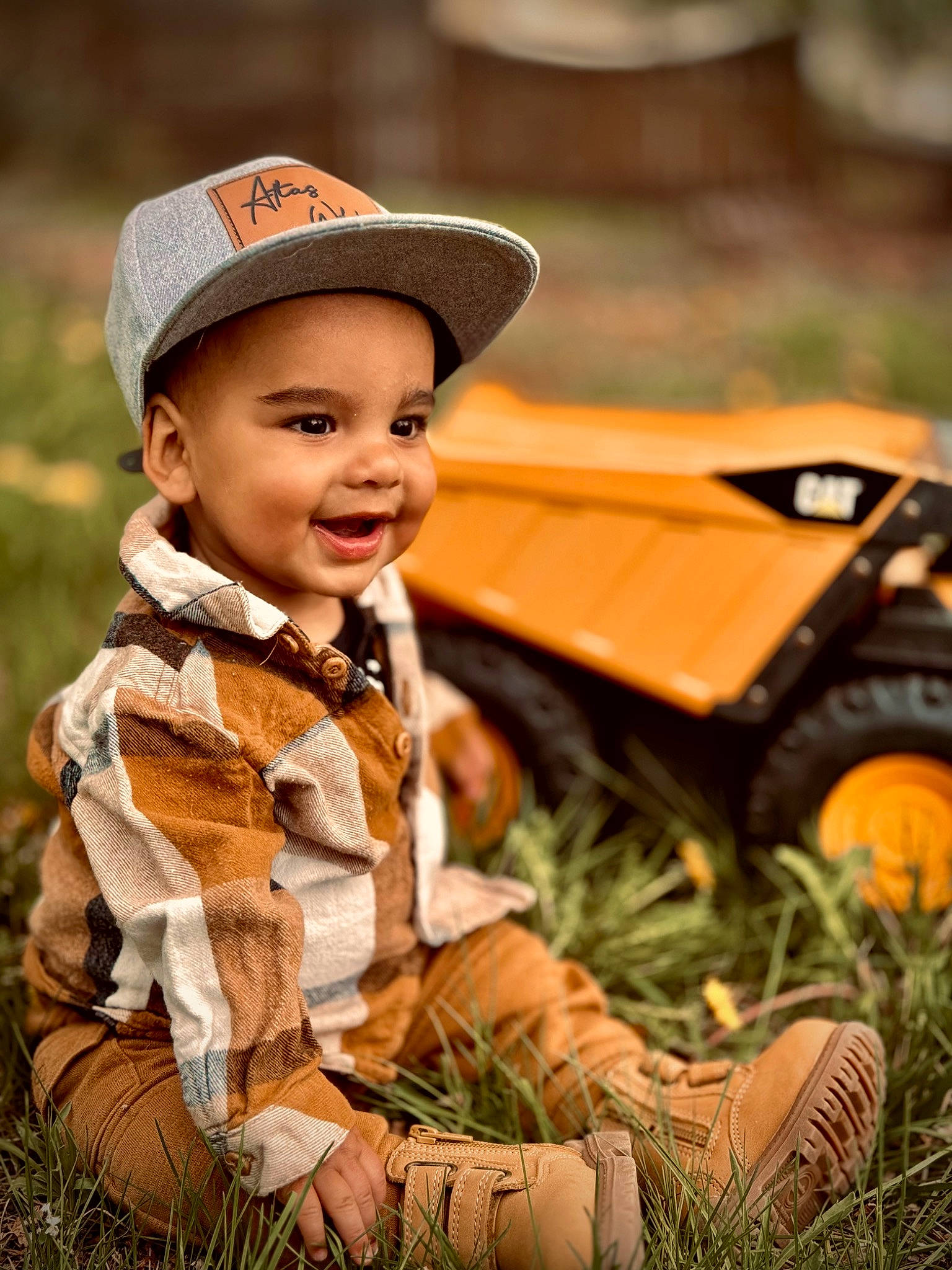Atlas joined the competition — help win amazing prizes! baby, baby_toddler_clothing, cap, child, facial_expression, grass, happy, hat, headwear, leaf, outerwear, people_in_nature, person, plant, skin, smile, sun_hat, tire, toddler, tree