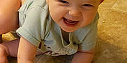 Rayven is registered to the contest to win money with this photo: baby, child, crawling, smiling, happy, floor, tile, indoor, person, cute, infant, hands, diaper, green_shirt, skin, young, joyful, toddler, face, head