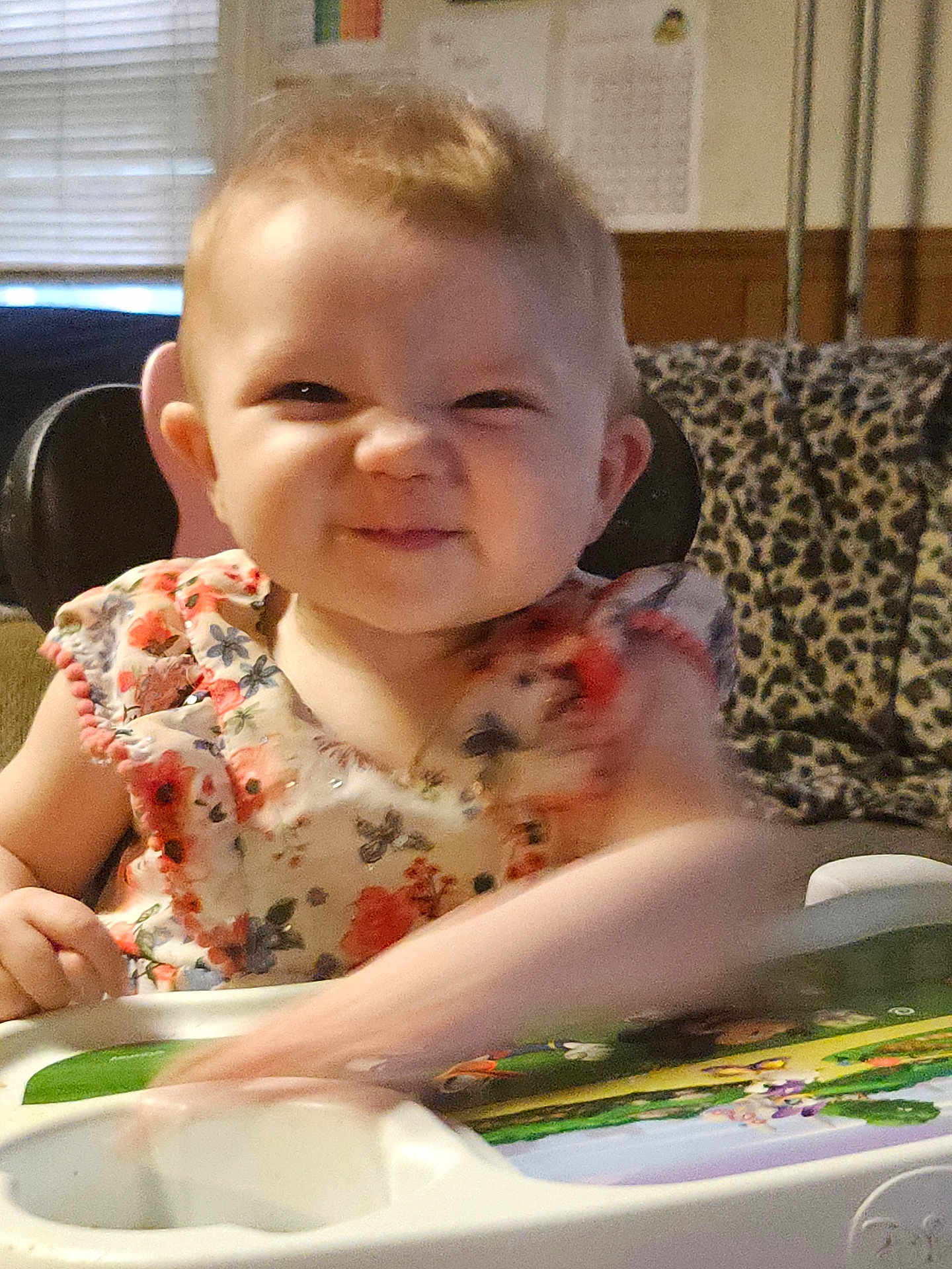 Rayven joined the competition — help win amazing prizes! toddler, child, high_chair, floral_dress, funny_face, indoor, play_tray, smile, person, baby, cute, furniture, leopard_print, blanket, arm, expression, head, hair, room, window