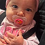 baby, pacifier, headband, pink, clothing, infant, car_seat, close_up, cute, child, face, hand, strap, apparel, accessory, adorable, person, young_child, indoors, portrait