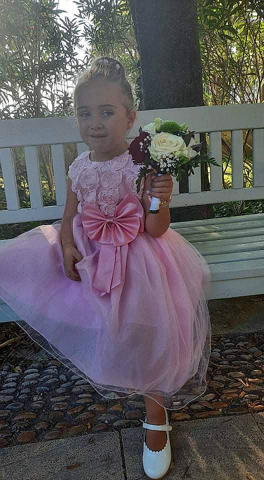 Lana participe au concours pour gagner de l'argent avec cette photo : baby_toddler_clothing, blond, bridal_accessory, bridal_clothing, bridal_party_dress, day_dress, dress, embellishment, event, flower, formal_wear, gown, happy, magenta, person, pink, plant, purple, shoulder, toddler