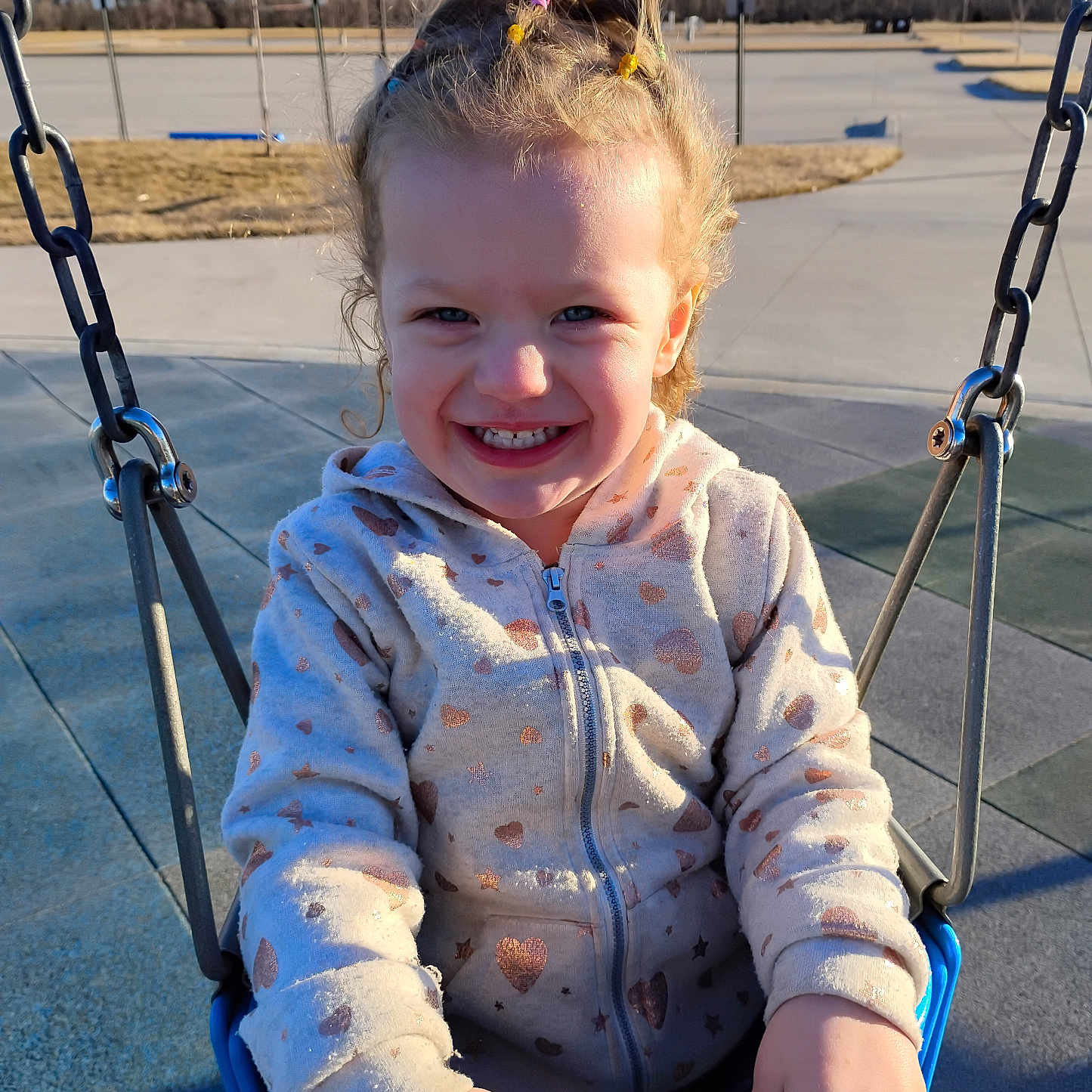 Ivy is registered to the contest to win money with this photo: baby, clothing, face, grass, happy, head, knitwear, laughing, nature, outdoorplayarea, outdoors, park, person, photography, plant, playarea, portrait, smile, swing, toy