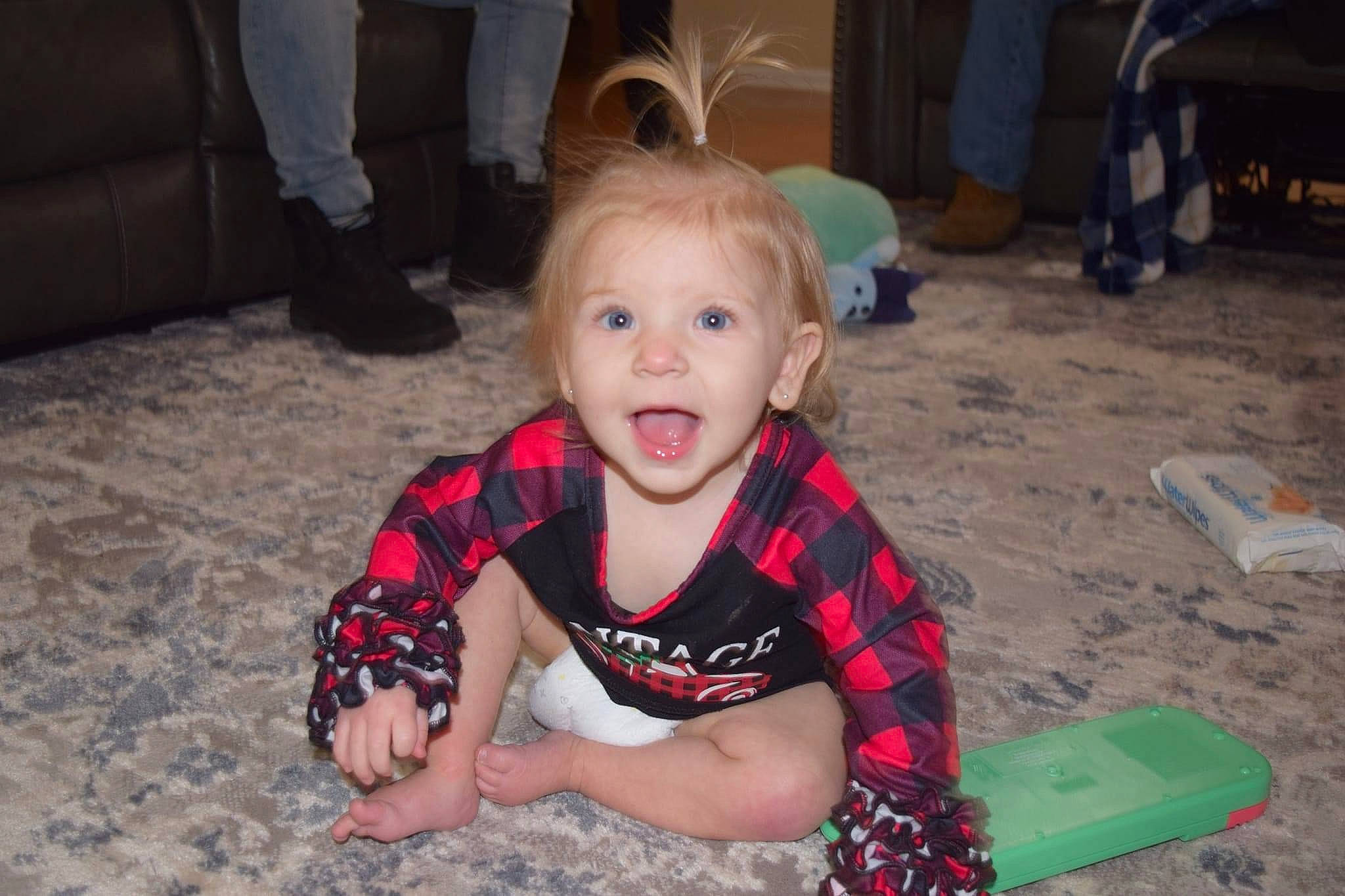 Oaklynn is registered to the contest to win money with this photo: baby, baby_toddler_clothing, black, carmine, chair, child, dress, event, flooring, fun, happy, holiday, leisure, pattern, person, play, sitting, smile, toddler, tree