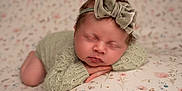 Ottilie joined the competition — help win amazing prizes! newborn, baby, sleeping, headband, bow, knitted_clothing, blanket, floral_pattern, soft_texture, portrait, peaceful, infant, cute, resting, closeup, child, indoors, cozy, warm, tender