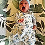 Ottilie joined the competition — help win amazing prizes! baby, infant, yawning, headband, bow, romper, floral_pattern, clothing, cute, indoor, person, child, newborn, patterned_background, fist, sleepy, adorable, portrait, laying_down, fabric