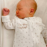 Mason joined the competition — help win amazing prizes! baby, newborn, sleeping, onesie, white, soft_lighting, peaceful, infant, cute, face, hand, ear, pale_skin, text_on_clothing, fabric, bed, portrait, closeup, cozy, sleep