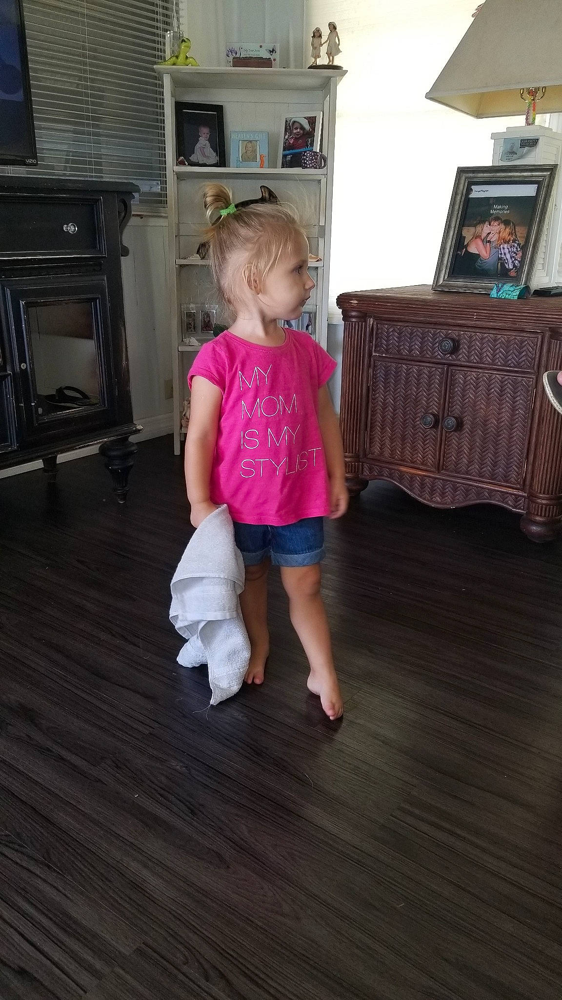 Brielle is registered to the contest to win money with this photo: chest_of_drawers, child, floor, flooring, fun, furniture, hardwood, human_body, joint, laminate_flooring, leg, person, pink, play, room, shoulder, sitting, standing, toddler, wood
