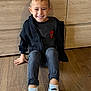 Swann participe au concours pour gagner de l'argent avec cette photo : child, smiling, boy, indoor, wood_floor, hoodie, spiderman, shirt, jeans, sneakers, white_shoes, socks, casual, furniture, dresser, wood_panel, happy, portrait, seated, floor