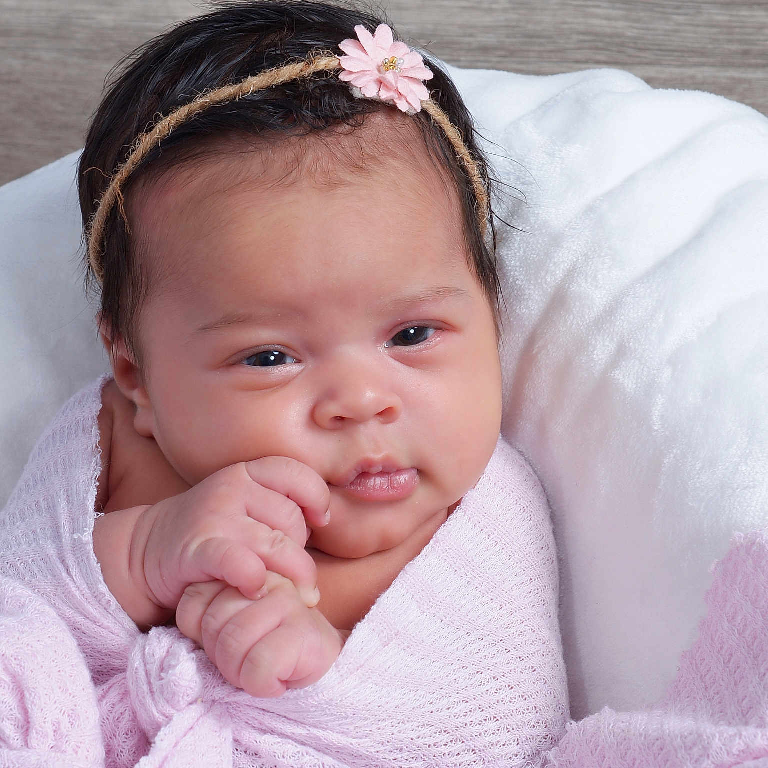 Loriana is registered to the contest to win money with this photo: baby, blanket, child, cozy, cute, expression, face, flower, hair, hands, headband, indoors, infant, newborn, person, pink, portrait, skin, soft, wrapped