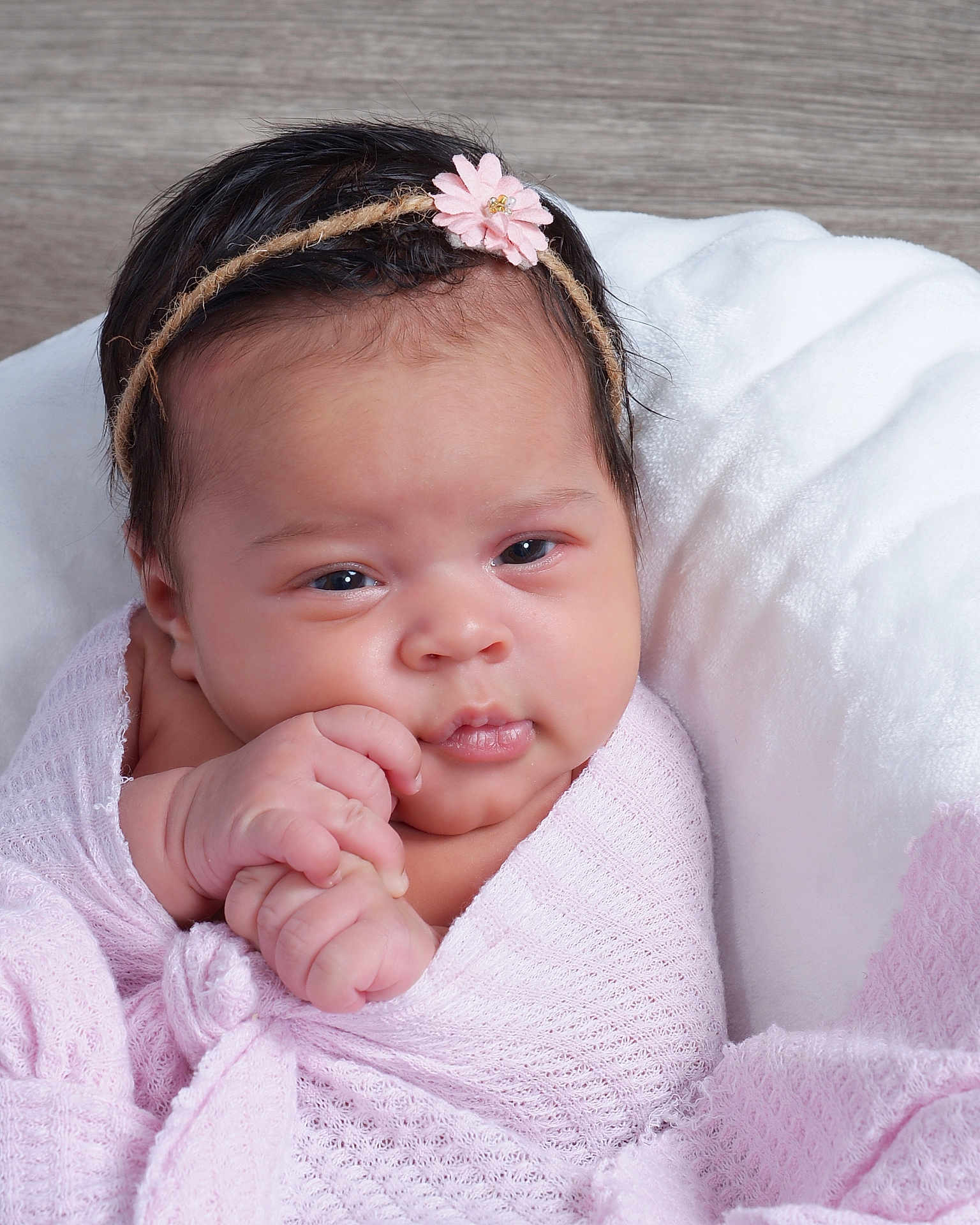 Loriana is registered to the contest to win money with this photo: baby, infant, headband, flower, pink, blanket, wrapped, hands, face, cute, portrait, soft, cozy, newborn, expression, skin, hair, indoors, child, person