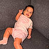 Loriana is registered to the contest to win money with this photo: baby, casual, child, couch, fabric, footwear, happy, indoor, infant, pink_clothing, portrait, raised_hand, relaxing, seated, shirt, shorts, skin, smiling, sofa, textile