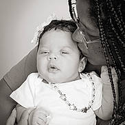 Loriana is registered to the contest to win money with this photo: baby, infant, adult, kiss, love, affection, portrait, black_and_white, glasses, braids, necklace, bow, hand, clothing, closeup, family, tenderness, expression, face, person