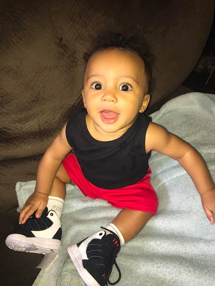 Legend is registered to the contest to win money with this photo: arm, baby, cheek, child, child_model, eye, face, footwear, fun, head, leg, lip, nose, person, pink, play, shoe, sitting, skin, smile