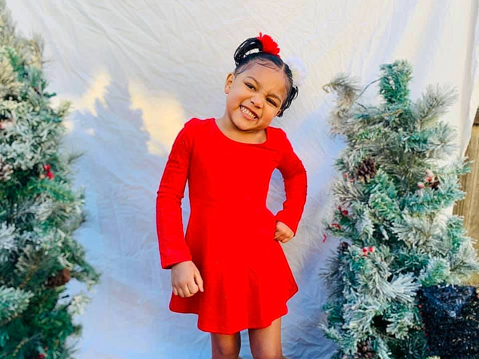 Adrianna is registered to the contest to win money with this photo: christmas_decoration, christmas_ornament, christmas_tree, dress, electric_blue, event, fun, green, hairstyle, happy, headwear, holiday, holiday_ornament, human_body, joy, ornament, people_in_nature, person, plant, sleeve