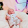 Isabelle is registered to the contest to win money with this photo: baby, infant, sleeping, cushion, blanket, headband, floral_outfit, soft_fabric, indoor, decor, butterfly, peaceful, child, newborn, cute, resting, portrait, comfort, cozy, smiling