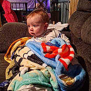 Levi joined the competition — help win amazing prizes! baby, blanket, casual, child, childhood, clothing, colorful, comfort, couch, cozy, curious, furniture, home, indoor, infant, portrait, relaxing, seated, soft, warm