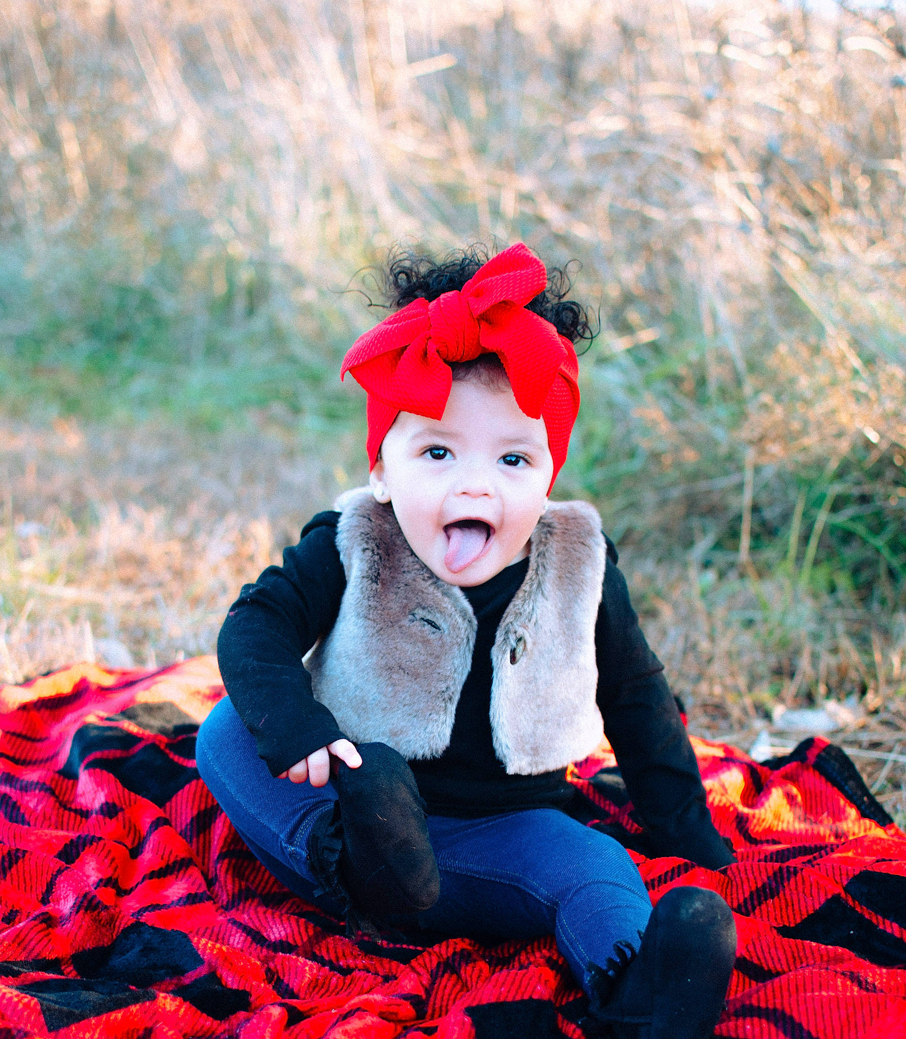 Nova Rose is registered to the contest to win money with this photo: child, child_model, costume, fur, happy, headgear, leaf, people_in_nature, person, photography, portrait_photography, red, sitting, smile, toddler