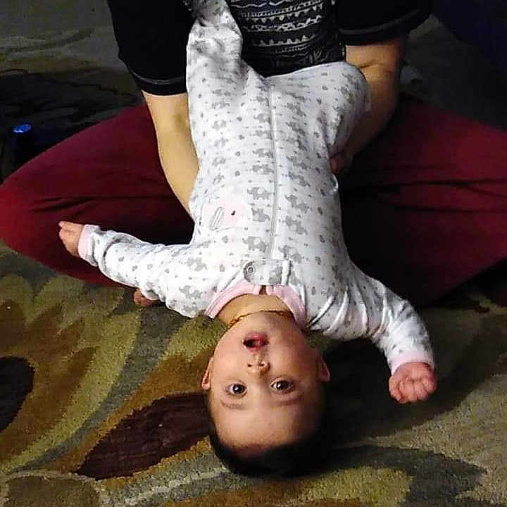 Ruby is registered to the contest to win money with this photo: barefoot, chest, flash_photography, floor, flooring, foot, gesture, happy, joint, knee, mammal, neck, shoulder, skin, sunglasses, thigh, toddler, tree, trunk, wood