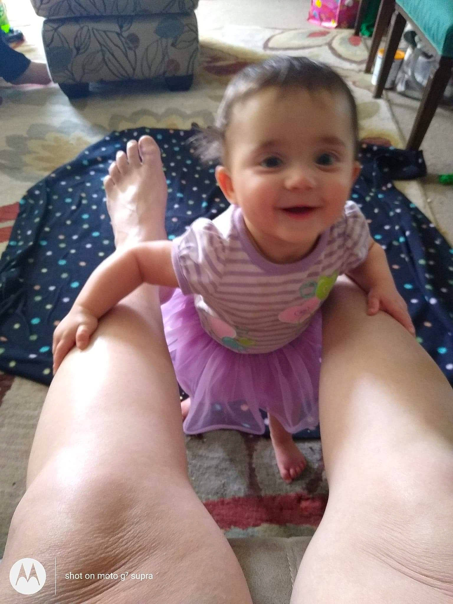 Ruby is registered to the contest to win money with this photo: baby, baby_toddler_clothing, black, cheek, comfort, finger, gesture, hand, happy, head, human_body, joint, joy, leg, mouth, muscle, person, purple, skin, smile