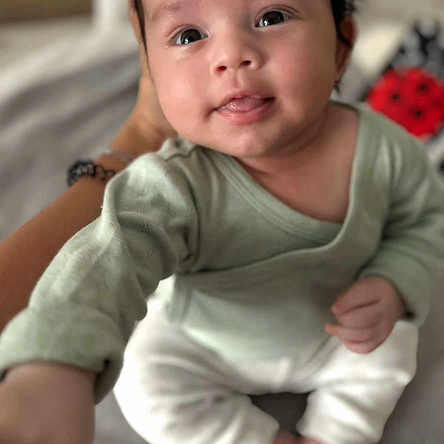 Nahil a rejoint le concours — aidez-le/la à gagner de superbes lots ! baby, baby_wear, child, clothing, cute, expression, eyes, face, hand, indoors, infant, person, portrait, reaching, sitting, skin, smile, soft_focus, support, young