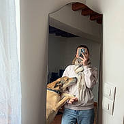 Naya participe au concours pour gagner de l'argent avec cette photo : mirror_selfie, dog, person, pet, scarf, jeans, sweater, smartphone, curtain, tiled_floor, mirror, home_interior, affectionate, paw, dog_collar, standing, living_space, casual_outfit, playful, nose_touch