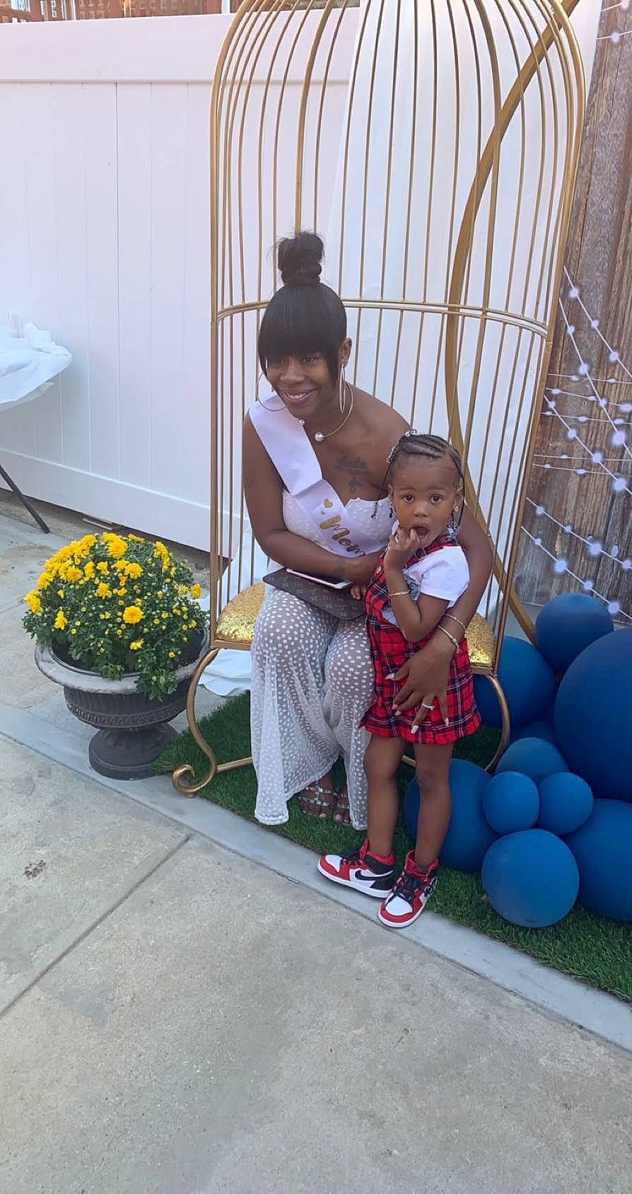 Malaysia is registered to the contest to win money with this photo: balloon, child, electric_blue, event, flower, flowerpot, fun, grass, happy, hat, houseplant, joy, leisure, party_supply, person, plant, recreation, sandal, sitting, sun_hat