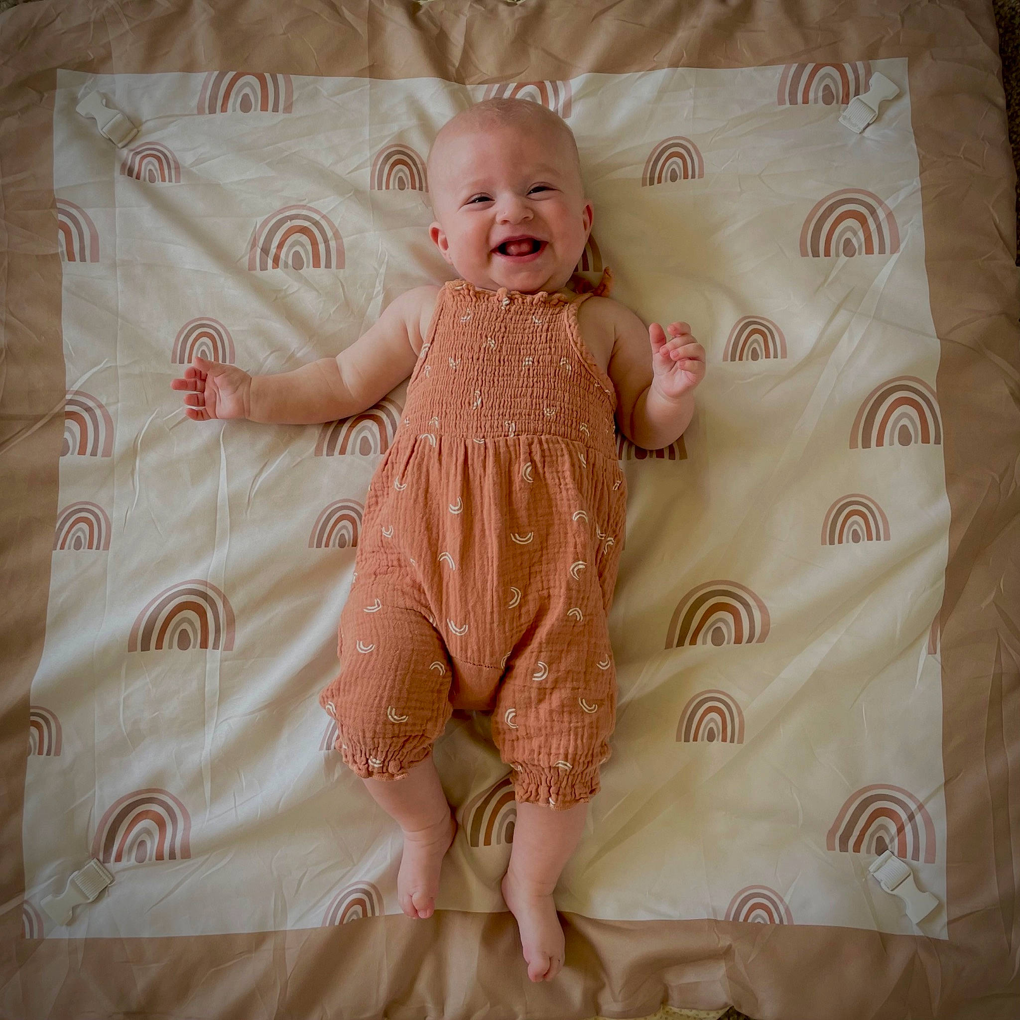 Lily is registered to the contest to win money with this photo: baby, baby_toddler_clothing, beige, brown, cheek, comfort, face, finger, hand, happy, joy, linens, pattern, peach, person, pink, skin, sleeve, smile, textile