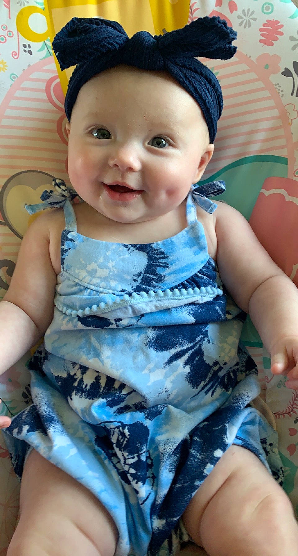 Kendall is registered to the contest to win money with this photo: azure, baby, baby_toddler_clothing, cap, cheek, dress, eye, face, facial_expression, finger, happy, headwear, iris, joy, organ, person, pink, product, skin, sleeve