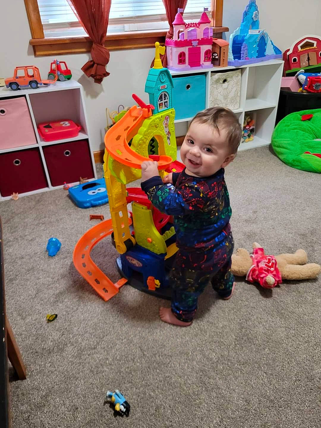 Anderson is registered to the contest to win money with this photo: baby, baby_playing_with_toys, baby_products, baby_toddler_clothing, baby_toys, child, event, floor, flooring, fun, kindergarten, leisure, person, play, product, room, sitting, toddler, toy, toy_vehicle