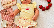 Addie is registered to the contest to win money with this photo: baby, child, infant, portrait, lying_down, sunglasses, yellow_outfit, headband, strawberries, fruit, purse, handbag, makeup, makeup_brushes, cosmetics, blanket, indoor, fashion, cute, smiling