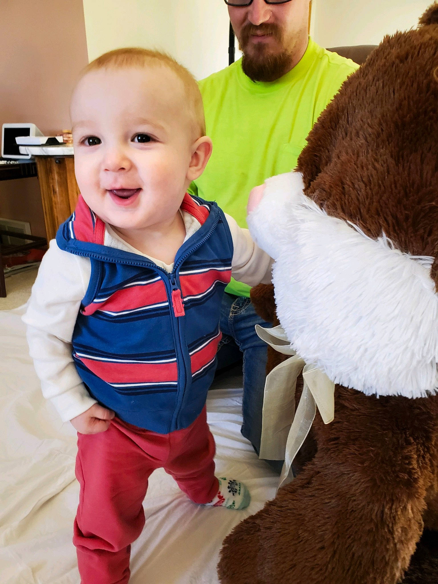 Kayce joined the competition — help win amazing prizes! baby, baby_toddler_clothing, beard, cap, child, companion_dog, flooring, fun, fur, fur_clothing, happy, headwear, human_body, joy, outerwear, person, sitting, skin, sleeve, smile