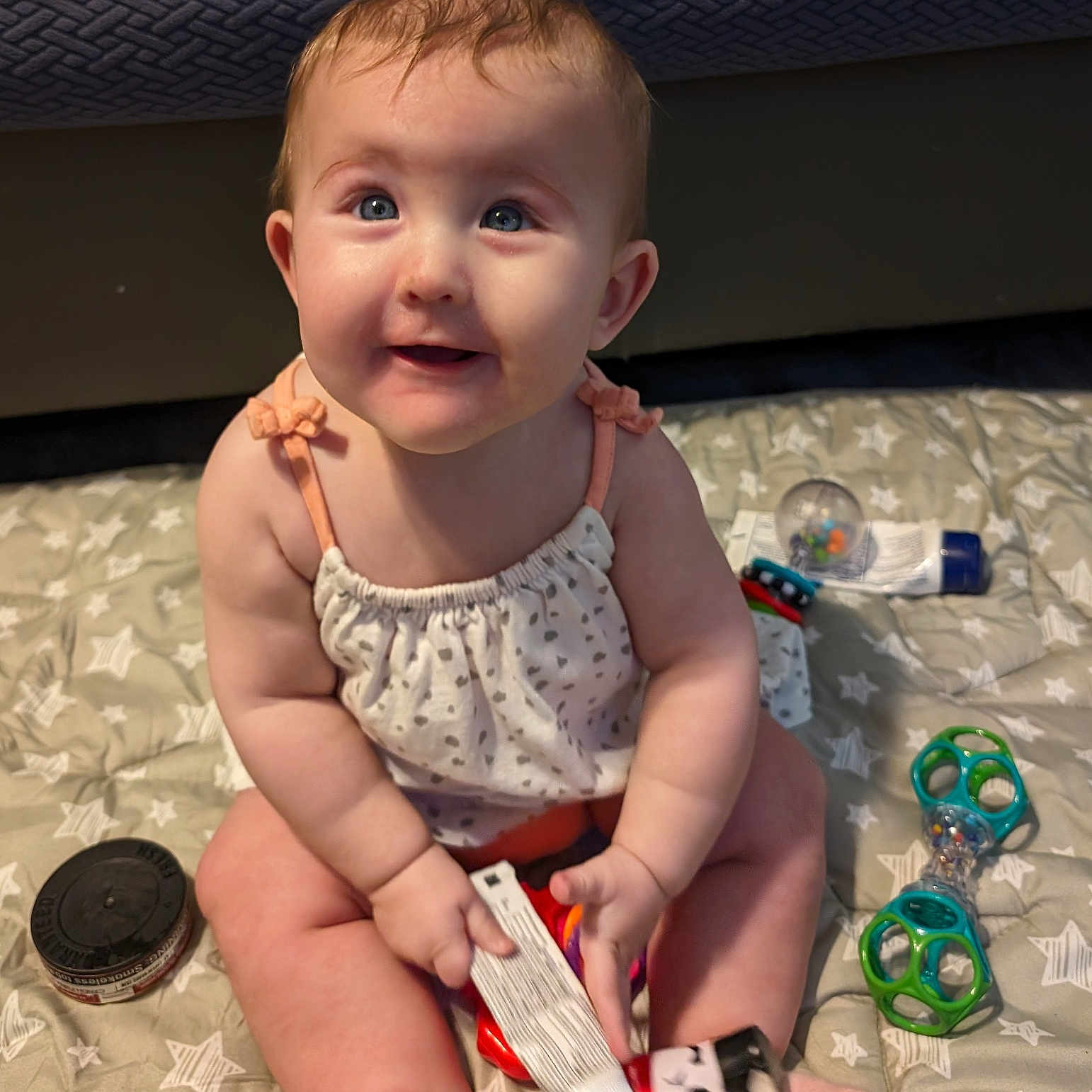 Gracie Rose is registered to the contest to win money with this photo: baby, bodypart, clothing, couch, dress, face, finger, footwear, furniture, hand, head, indoors, person, photography, portrait, sandal, scissors, shoe, shorts, sitting