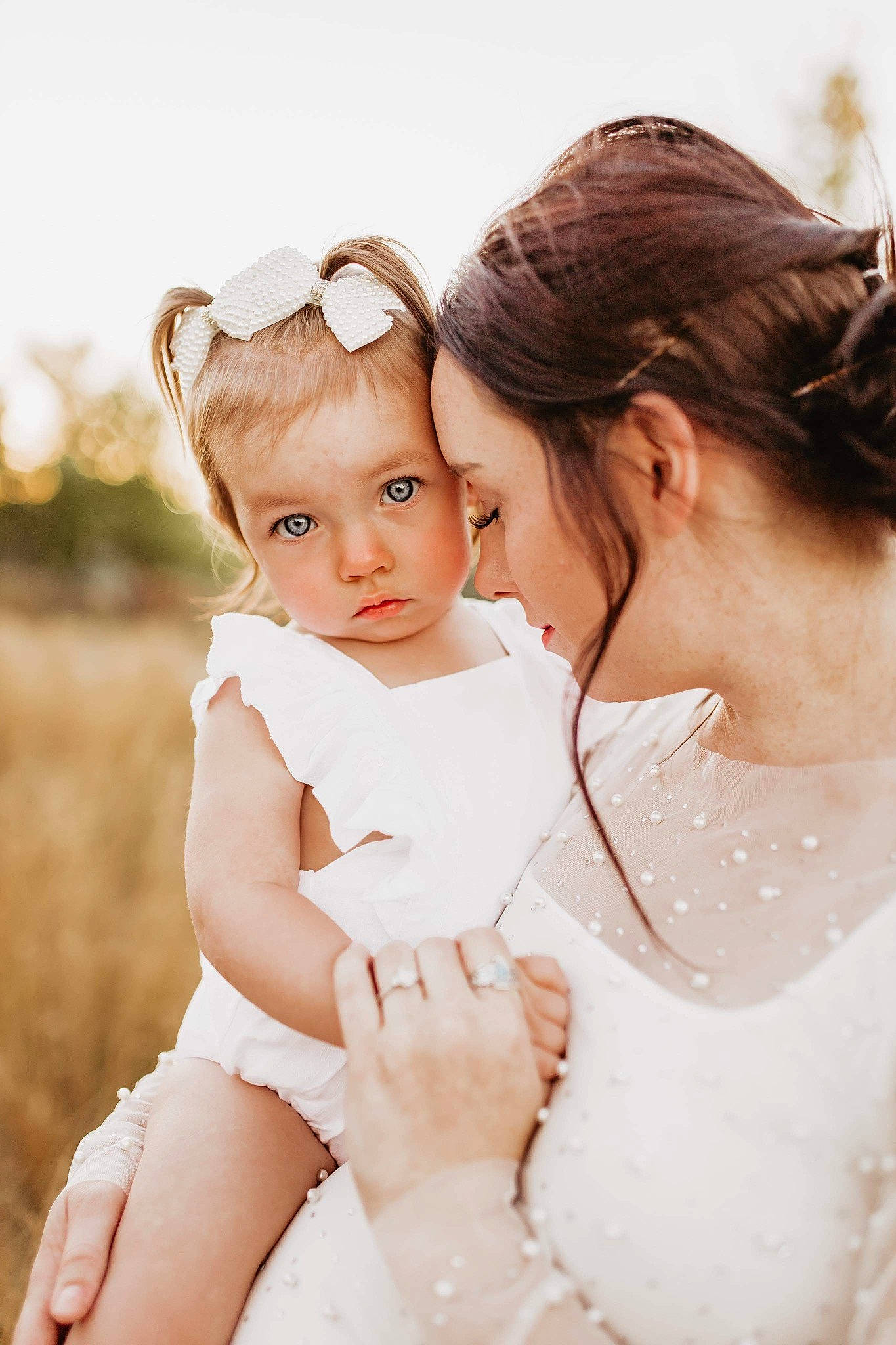 Aubriel is registered to the contest to win money with this photo: baby, beauty, bridal_accessory, bridal_clothing, bride, dress, event, face, flash_photography, gesture, hair, happy, head, headpiece, interaction, people_in_nature, person, shoulder, skin, toddler