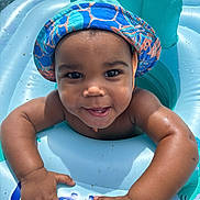 Jordy joined the competition — help win amazing prizes! arms, baby, child, cute, face, float, fun, happy, hat, infant, outdoor, playful, pool, skin, smiling, splash, summer, sunlight, vacation, water