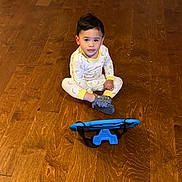 Aron joined the competition — help win amazing prizes! toddler, child, pajamas, banana_pattern, wooden_floor, toy_car, toy_dinosaur, toy_truck, tablet, indoor, playtime, colorful, sitting, floor, young_child, casual, home, electronics, curious, cute