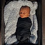 newborn, baby, sleeping, swaddle, black_clothing, wooden_crate, fluffy_blanket, infant, cozy, peaceful, soft_light, portrait, indoors, resting, cute, child, wrapped, blanket, face, head