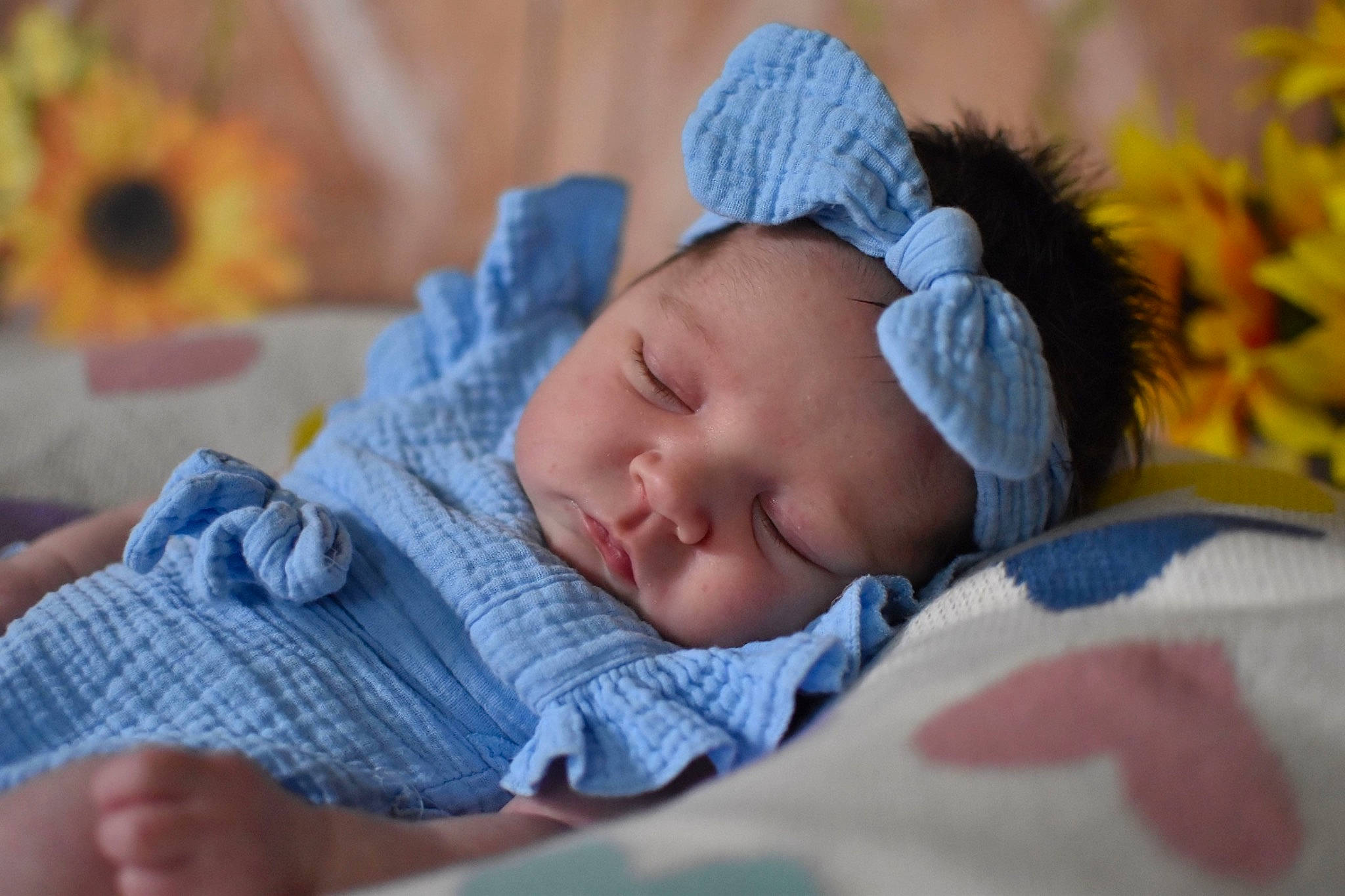 Kaitlynn is registered to the contest to win money with this photo: azure, baby, baby_products, baby_sleeping, baby_toddler_clothing, beanie, bedding, bedtime, cap, cheek, child, comfort, grass, happy, headwear, knit_cap, linens, person, sitting, skin