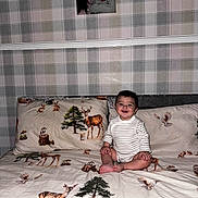 Salim is registered to the contest to win money with this photo: animal_print, baby, bed, bedding, child, deer, fabric, happy, indoor, newborn, owl, person, photo_frame, pillow, plaid_wallpaper, portrait, smiling, squirrel, tree, woman